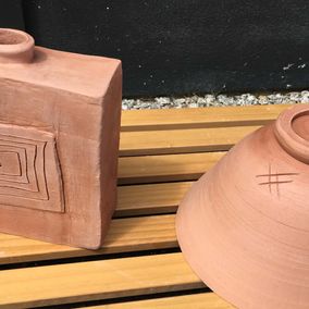 two brown pots that has been styled