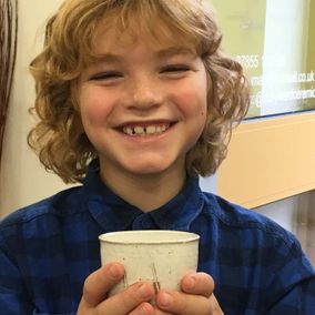 A child with his bespoke pottery 
