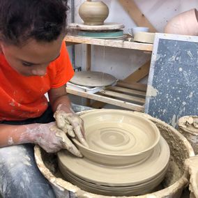 A girl making some bespoke pottery 