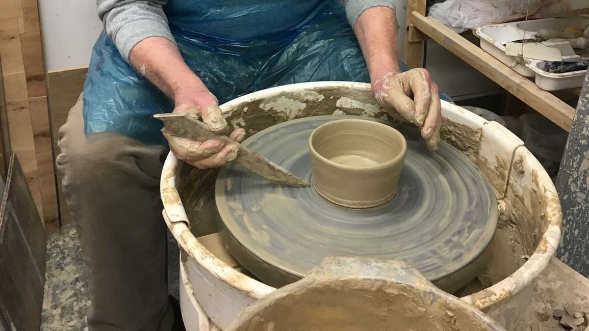 A older man working on some pottery