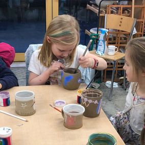Children decorating pottery