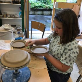 A young girl working on bespoke pottery 