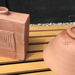 two brown pots that has been styled