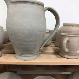 A jug and cups that are ready for decoration