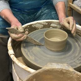 A older man working on some pottery